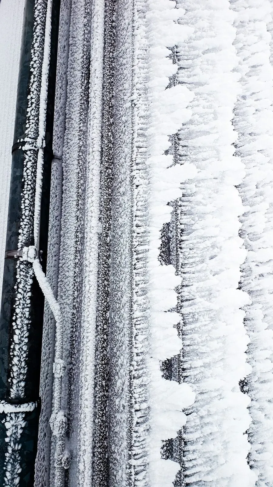 Ice buildup on refrigerant lines near an outdoor AC unit