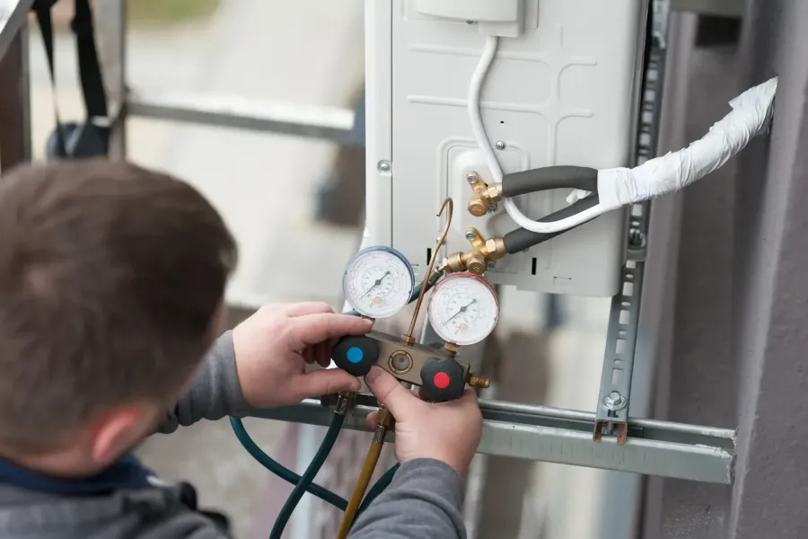 An HVAC technician reviewing replacement system specifications on site